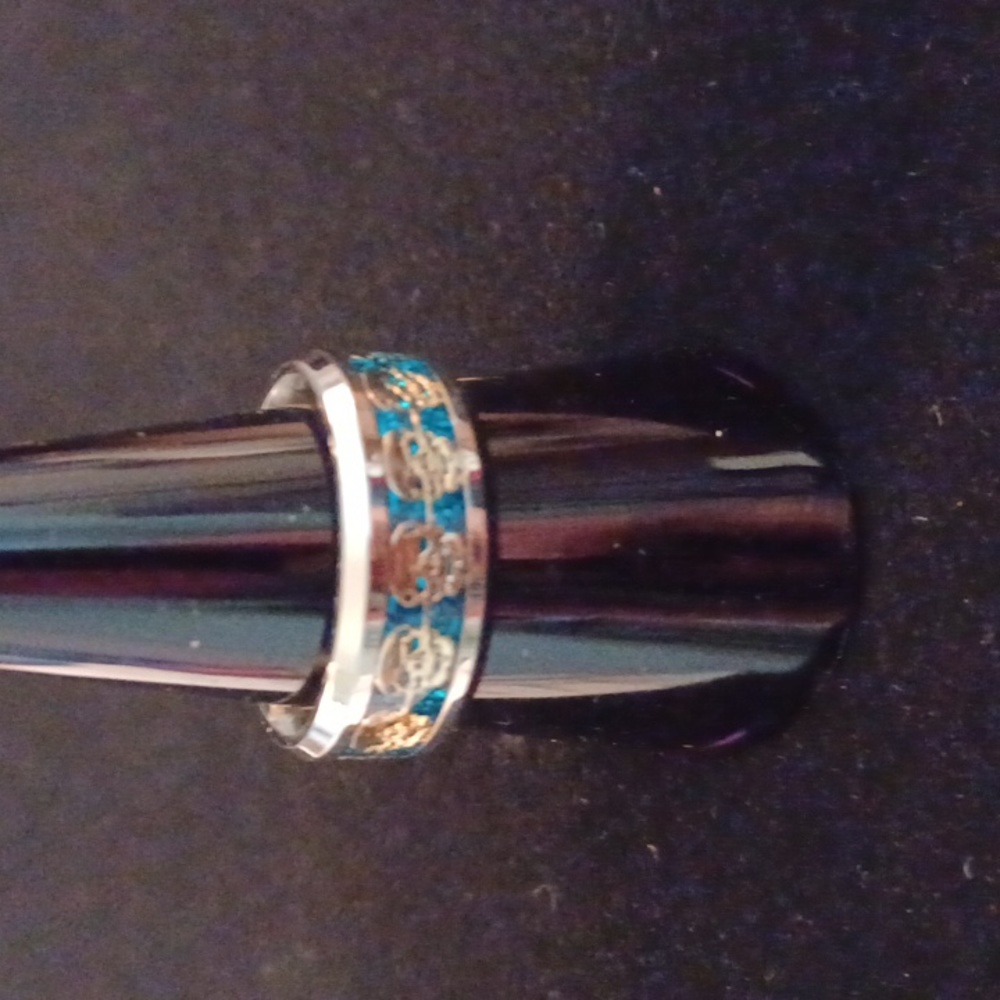 Silvertone skull ring with turquoise accents